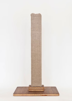 A tall cat scratching post with a walnut base