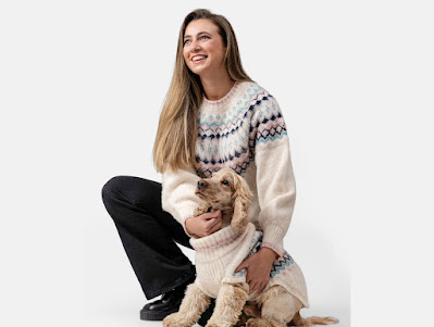 A young woman and her cocker spaniel wearing matching fair isle sweaters