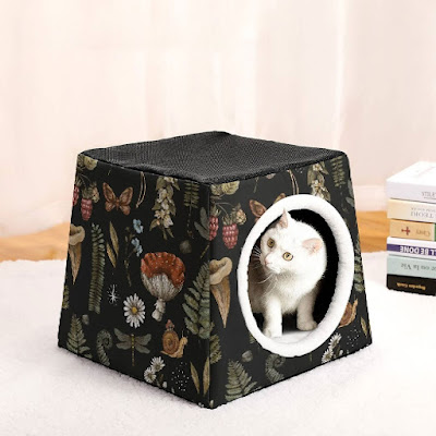 A black cottagecore cat cave with a fungi and floral design