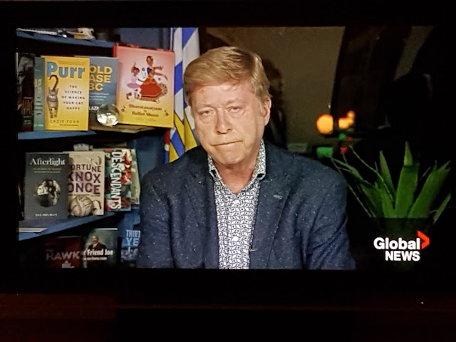 A copy of Purr and one of Wag on Keith Baldrey's bookshelf on Global BC in December 2022