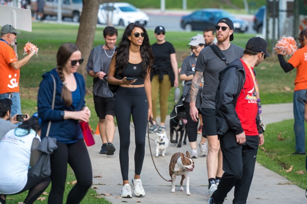 Participants walk dogs at the “Strut Your Mutt” fundraiser for...