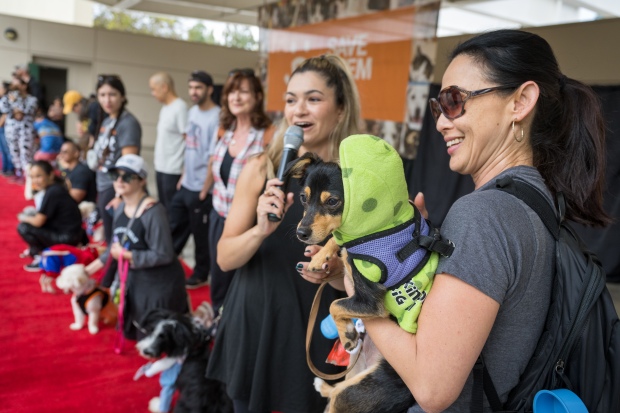 Nikki Bilderback, right, and her dog “Maverick” are introduced by...