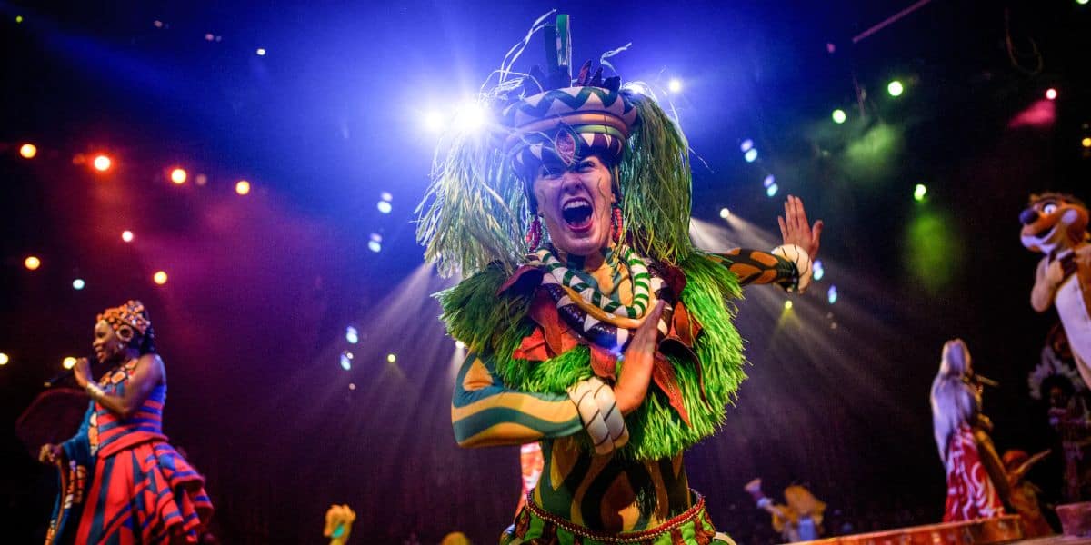 A dancer performs in a headdress in the Festival of the Lion King