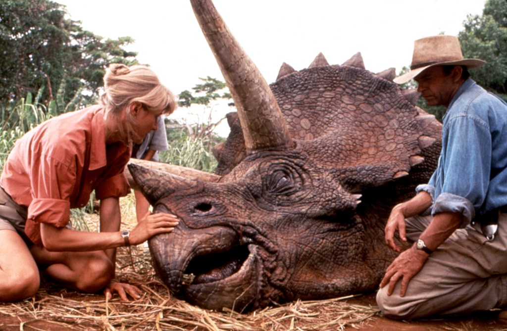 JURASSIC PARK, Laura Dern, Sam Neill, with triceratops, 1993, (c)MCA/courtesy Everett Collection