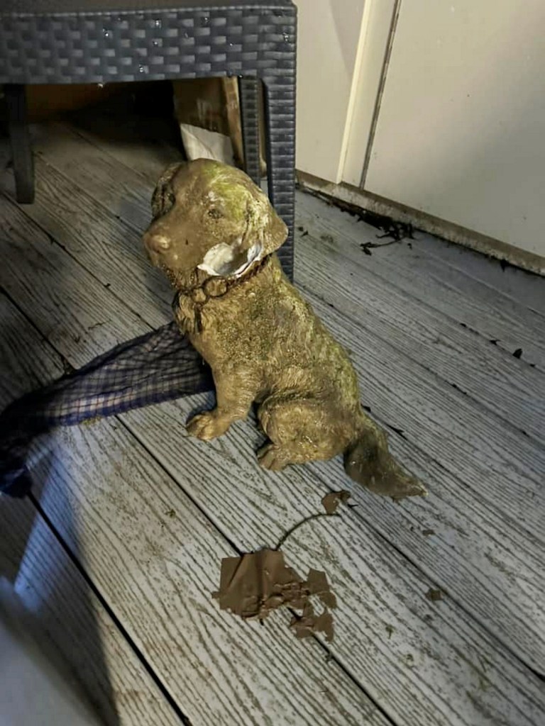 A 2ft tall ornamental statue of a Spaniel sitting on the floor.