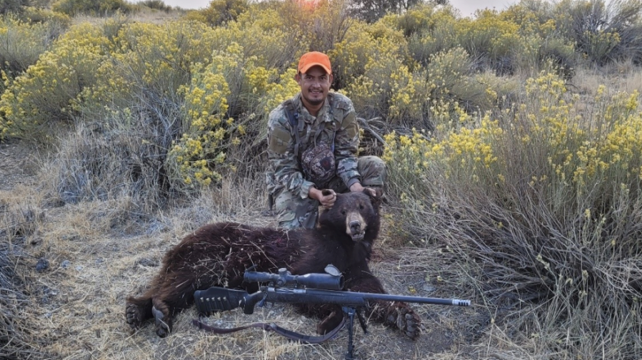 Gilberto Lopez Hernandez poses with a recently killed bear on Sept. 25, 2021. (Ventura County District Attorney's Office/California Fish and Wildlife)