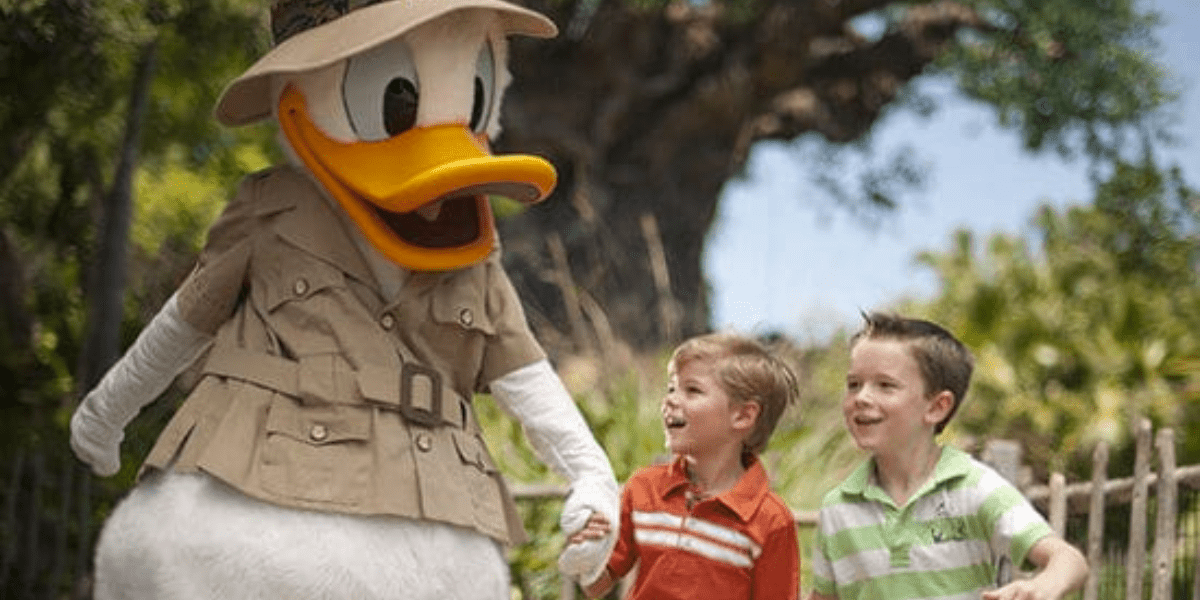 Donald duck holds two little boys hands.